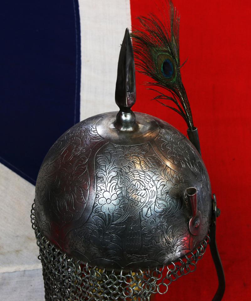 An Indian Kulah Khud Helmet With Fully Etched and Engraved With Exotic Birds and Figures. Mounted With the Traditional Spike & Peacock Feather Plume Mounts