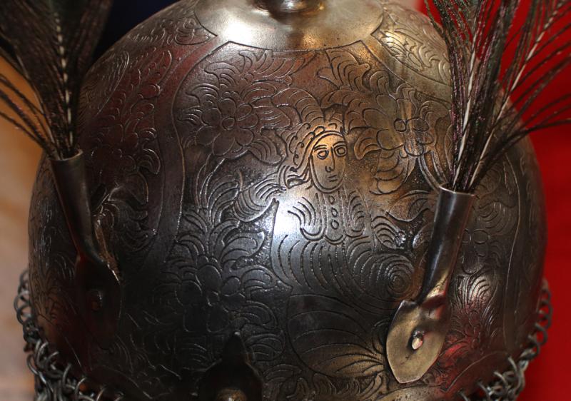 An Indian Kulah Khud Helmet With Fully Etched and Engraved With Exotic Birds and Figures. Mounted With the Traditional Spike & Peacock Feather Plume Mounts