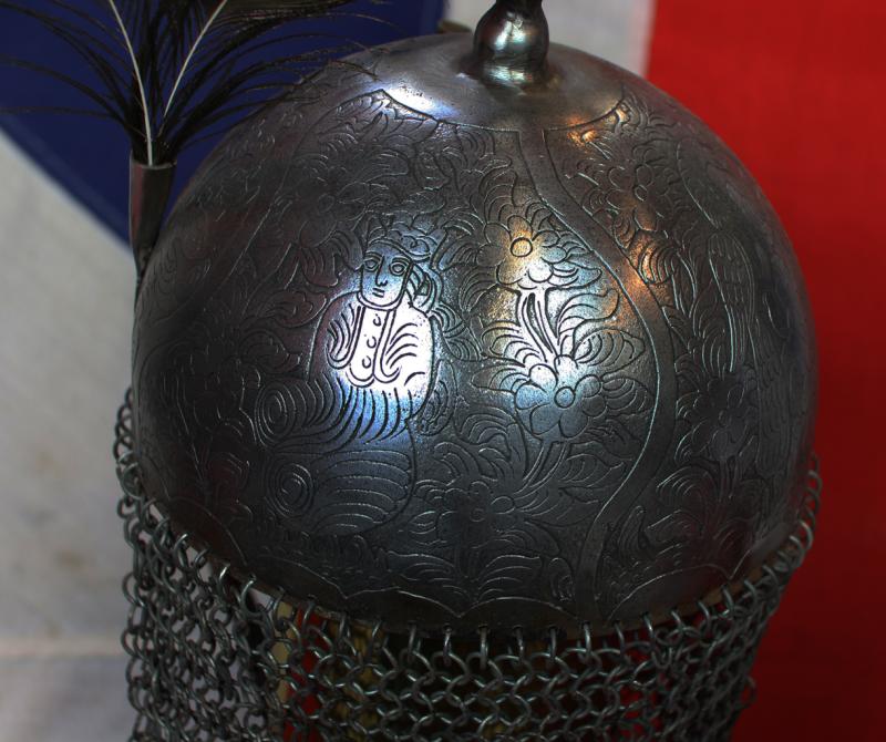 An Indian Kulah Khud Helmet With Fully Etched and Engraved With Exotic Birds and Figures. Mounted With the Traditional Spike & Peacock Feather Plume Mounts