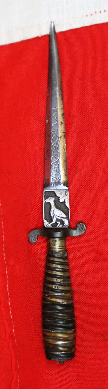 Italian Hunting Dagger, Republic of Genoa, Ligurian 17th - 18th Century. Spiral Twist Carved Multi Coloured Horn with Silver Inserts. Blade with Baluster Shaped Forte Of A Finely Engraved Ricasso, Two Symmetrical Edges To The Tip.
