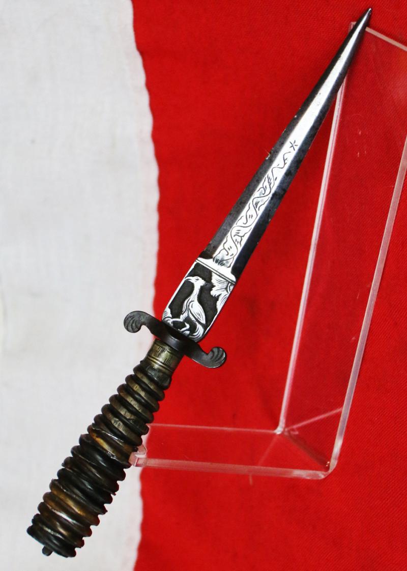 Italian Hunting Dagger, Republic of Genoa, Ligurian 17th - 18th Century. Spiral Twist Carved Multi Coloured Horn with Silver Inserts. Blade with Baluster Shaped Forte Of A Finely Engraved Ricasso, Two Symmetrical Edges To The Tip.