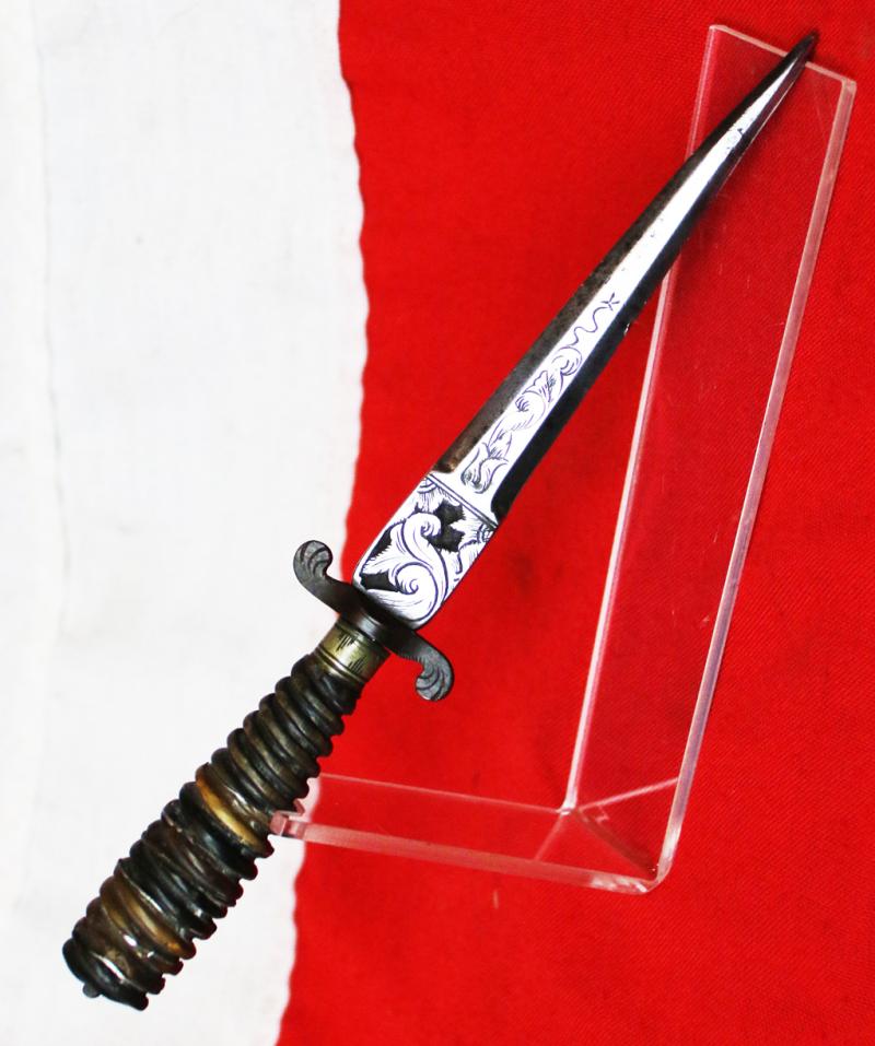 Italian Hunting Dagger, Republic of Genoa, Ligurian 17th - 18th Century. Spiral Twist Carved Multi Coloured Horn with Silver Inserts. Blade with Baluster Shaped Forte Of A Finely Engraved Ricasso, Two Symmetrical Edges To The Tip.
