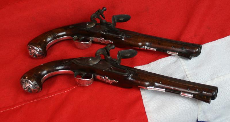 A Pair Of Finest Irish Silver Mounted Holster Pistols By John Govers Of Dame St. Dublin 1760. Finest Silver Cartouches Each One Engraved With The Original Owner, An Irish Duke's, Noble Crests, Of Irish Ducal Crowned Lions Passant, Set In Noble Shields