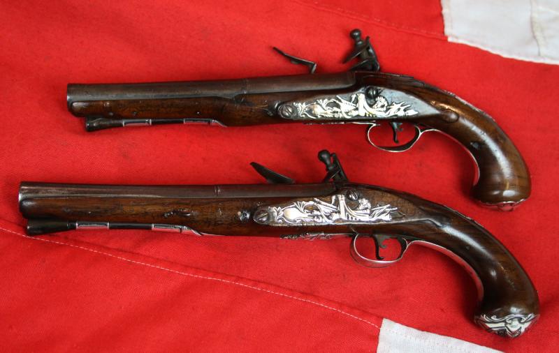 A Pair Of Finest Irish Silver Mounted Holster Pistols By John Govers Of Dame St. Dublin 1760. Finest Silver Cartouches Each One Engraved With The Original Owner, An Irish Duke's, Noble Crests, Of Irish Ducal Crowned Lions Passant, Set In Noble Shields