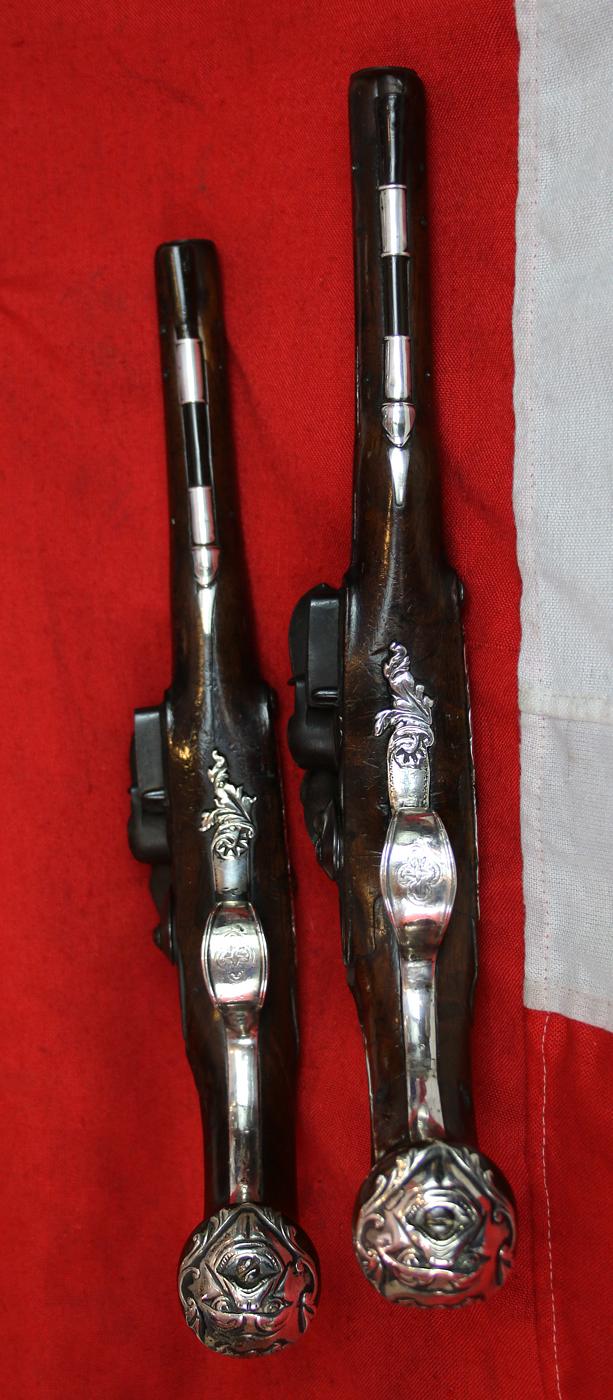 A Pair Of Finest Irish Silver Mounted Holster Pistols By John Govers Of Dame St. Dublin 1760. Finest Silver Cartouches Each One Engraved With The Original Owner, An Irish Duke's, Noble Crests, Of Irish Ducal Crowned Lions Passant, Set In Noble Shields